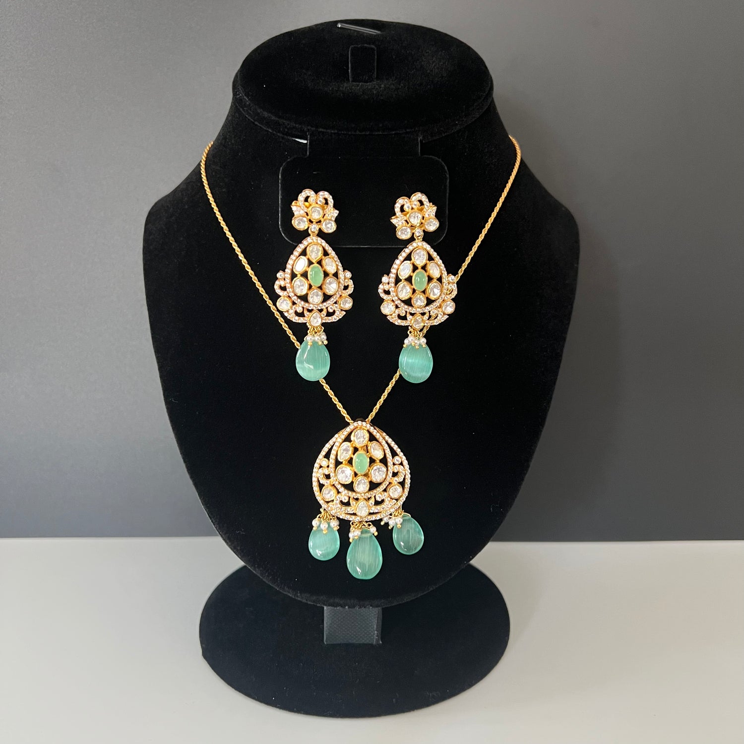 Moissanite betel vine pendant set with Russian emerald drops in 92.5 silver and 22k gold microplating